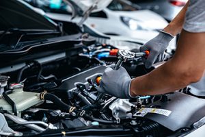 Mechanic,Using,Wrench,While,Working,On,Car,Engine,At,Garage - Meineke Chattanooga Regular Maintenance | Meineke Car Care | Hixson, TN