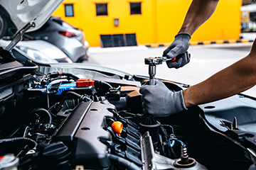 Mechanic,Using,Wrench,While,Working,On,Car,Engine,At,Garage - Meineke Chattanooga